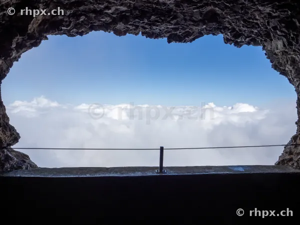 View from a rock opening at Mount Pilatus over a sea of clouds