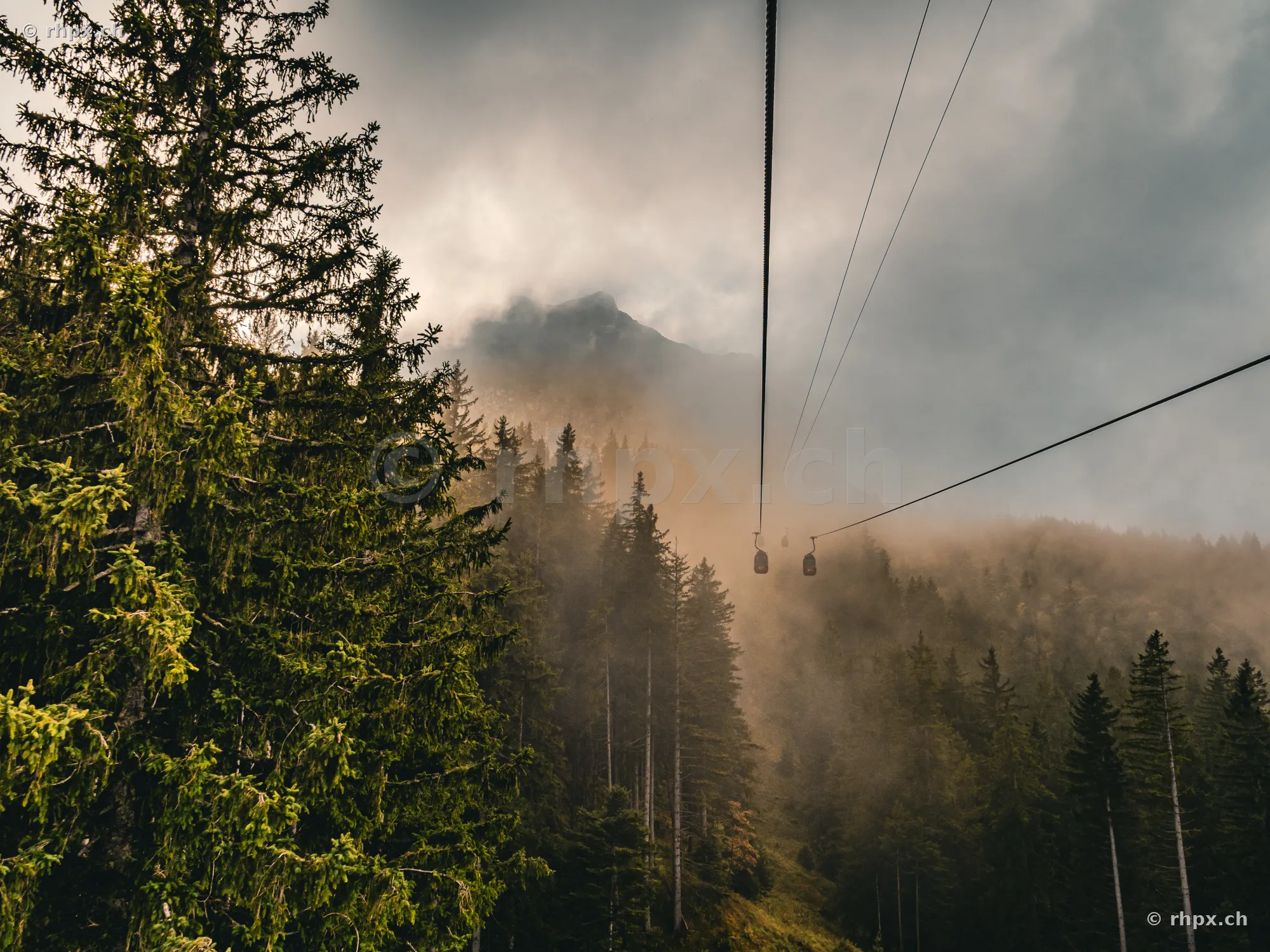 View from a cable car towards the misty and cloud-covered Mount Pilatus near Lucerne.