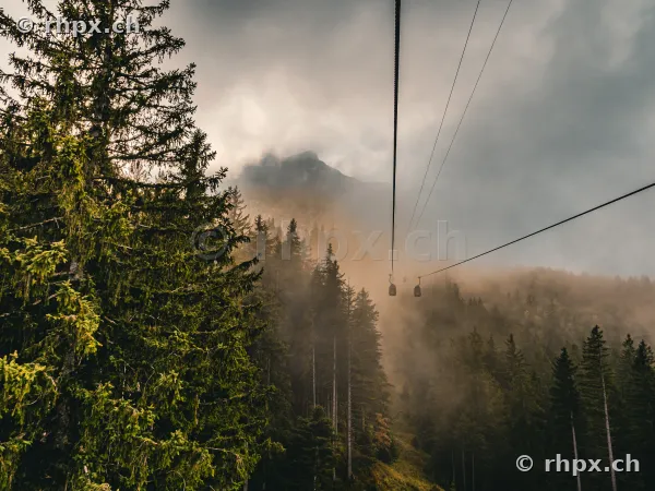 View from a cable car towards the misty and cloud-covered Mount Pilatus near Lucerne.