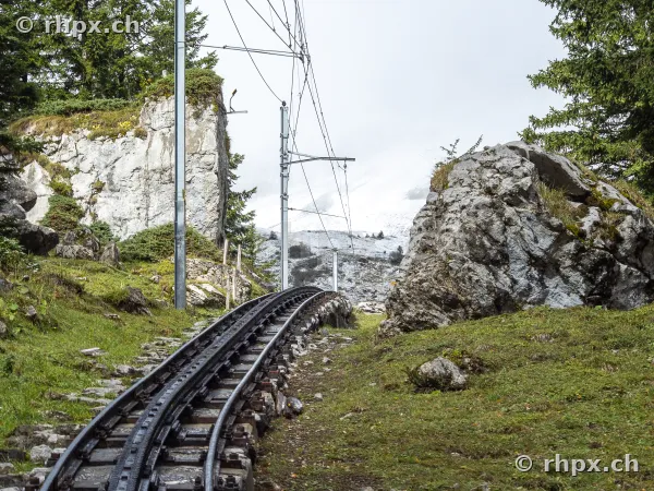 Tracks of the Pilatus railway lead through a rocky mountain landscape