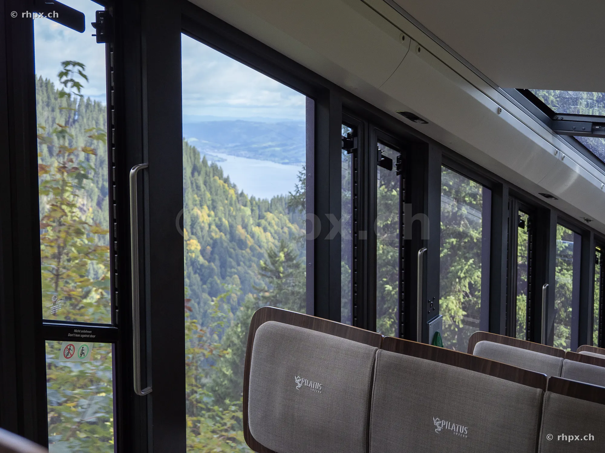 View from a carriage of the Pilatus Railway through the panoramic windows towards Lake Lucerne