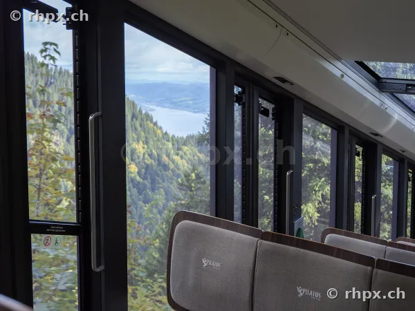 View from a carriage of the Pilatus Railway through the panoramic windows towards Lake Lucerne