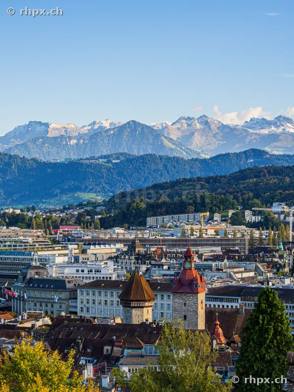 View over the roofs of Lucerne with Musegg towers and the Alps in the background