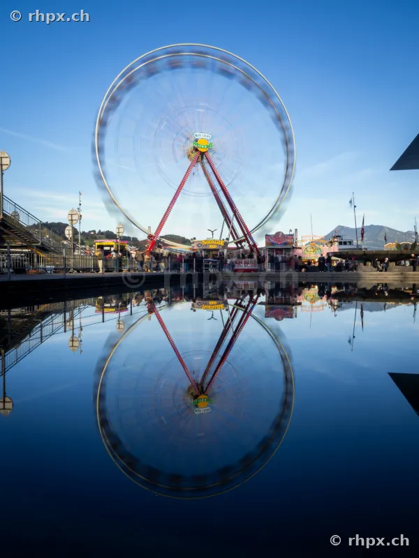 Ferris wheel at Lucerne lake basin with reflection in the water