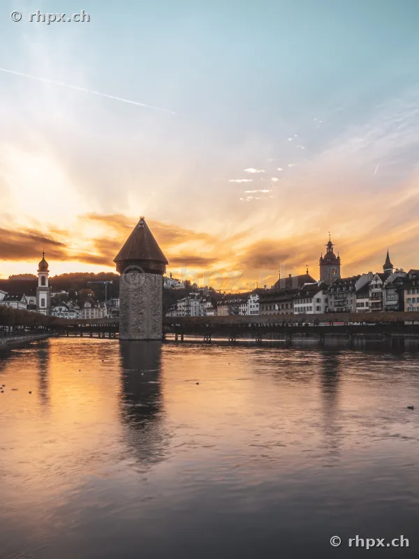 Water Tower and Chapel Bridge in Lucerne during sunset on the Reuss river
