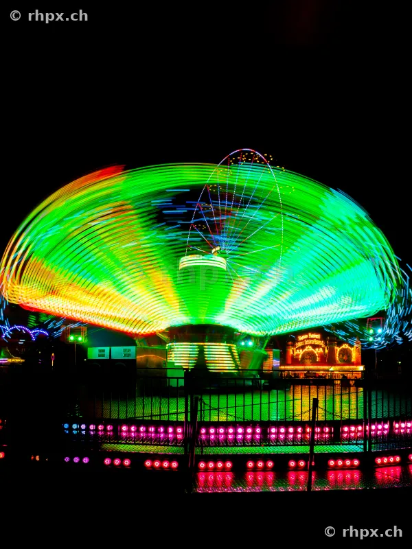 Long exposure of a chain carousel at a funfair at night