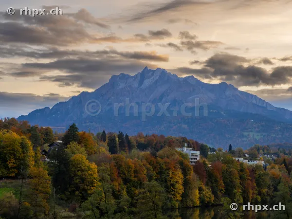 Mount Pilatus above an autumn colored forest at dusk
