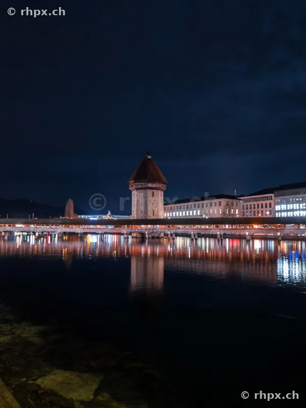 Water tower and Chapel Bridge in Lucerne illuminated at night