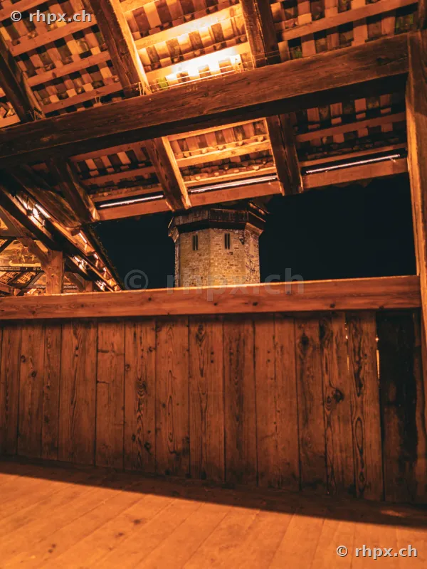 View of the Wasserturm from inside the covered Chapel Bridge in Lucerne at night
