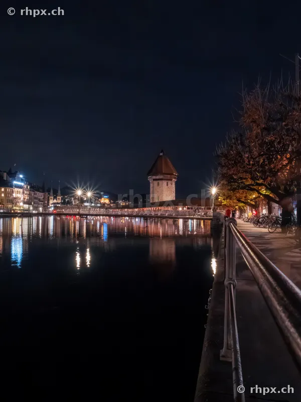 View of the nocturnal Chapel Bridge with Water Tower in Lucerne