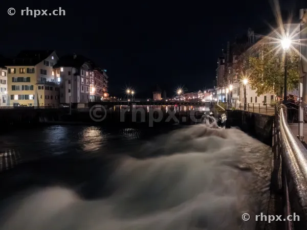The Reuss River at night with illuminated building facades in Lucerne