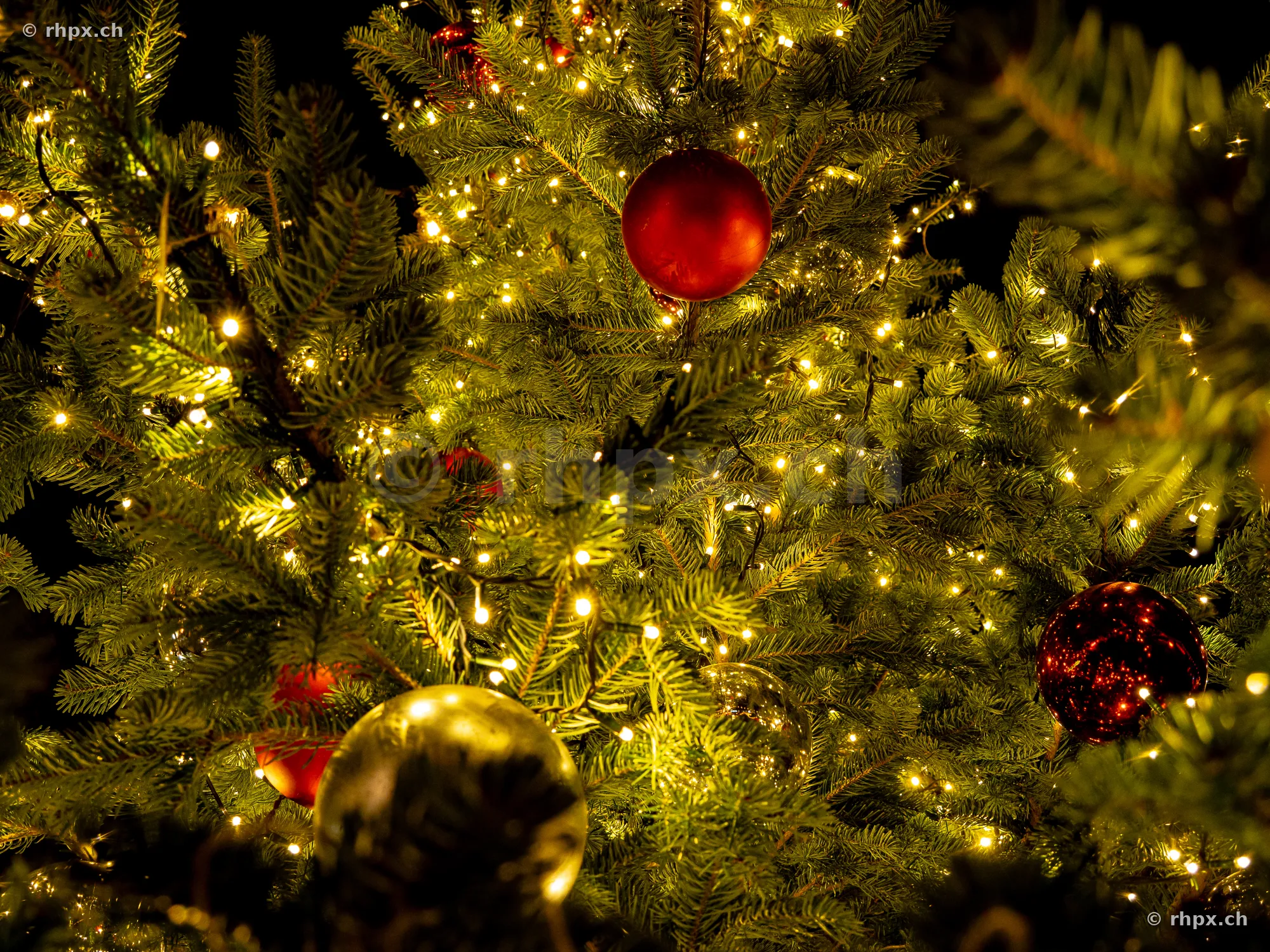 Detail shot of a decorated Christmas tree with fairy lights and ornaments in Lucerne
