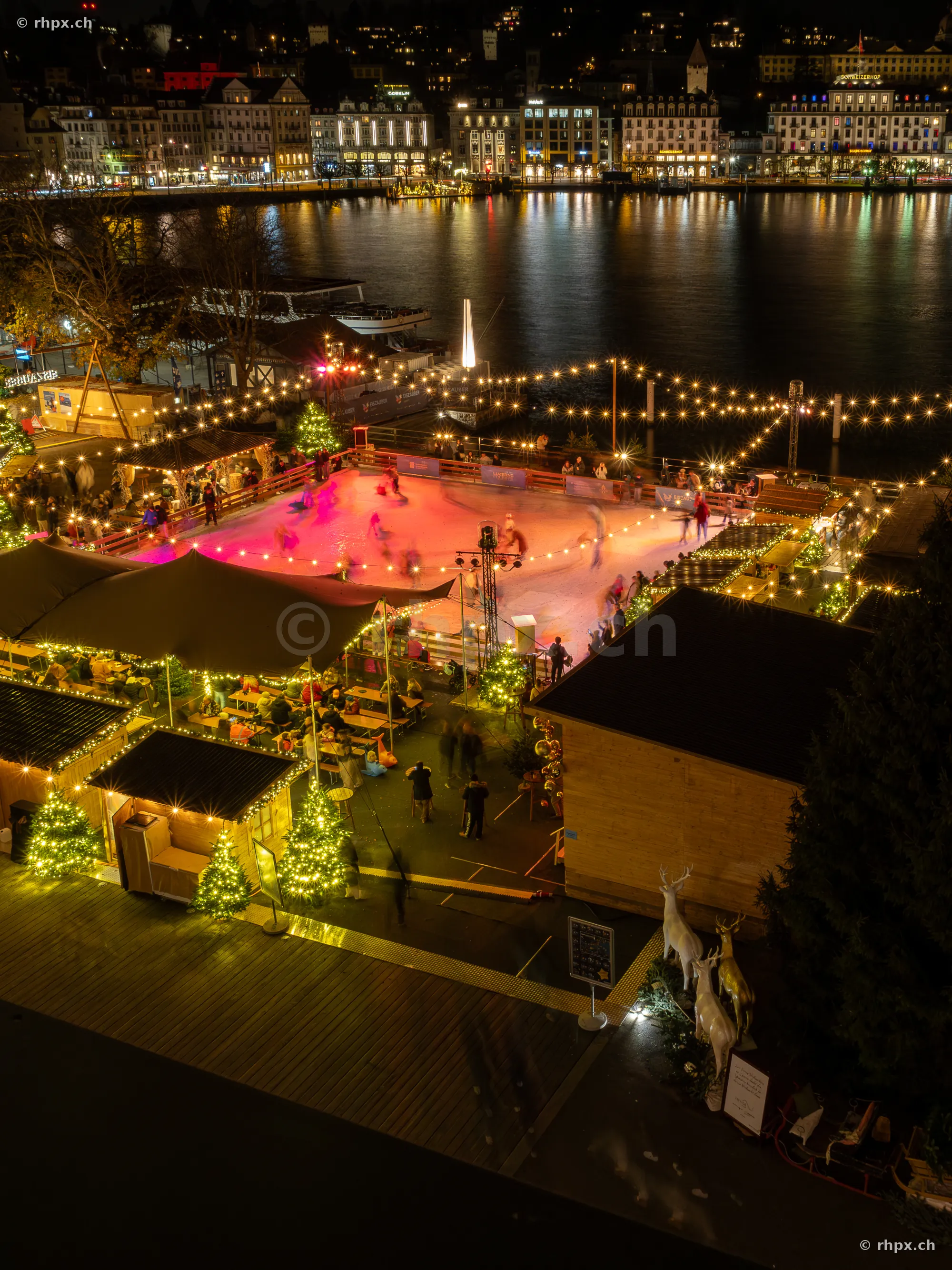 Christmas ice skating rink against the nocturnal backdrop of Lake Lucerne