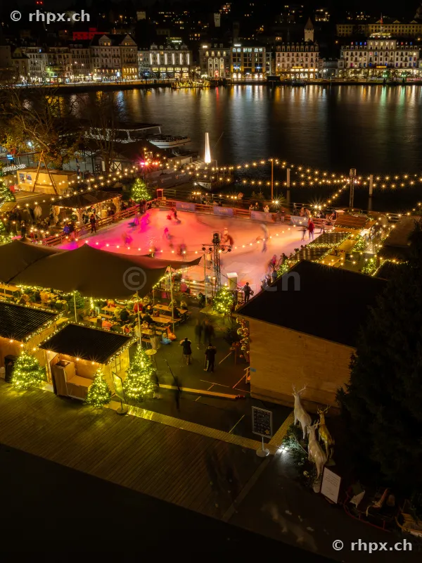 Christmas ice skating rink against the nocturnal backdrop of Lake Lucerne