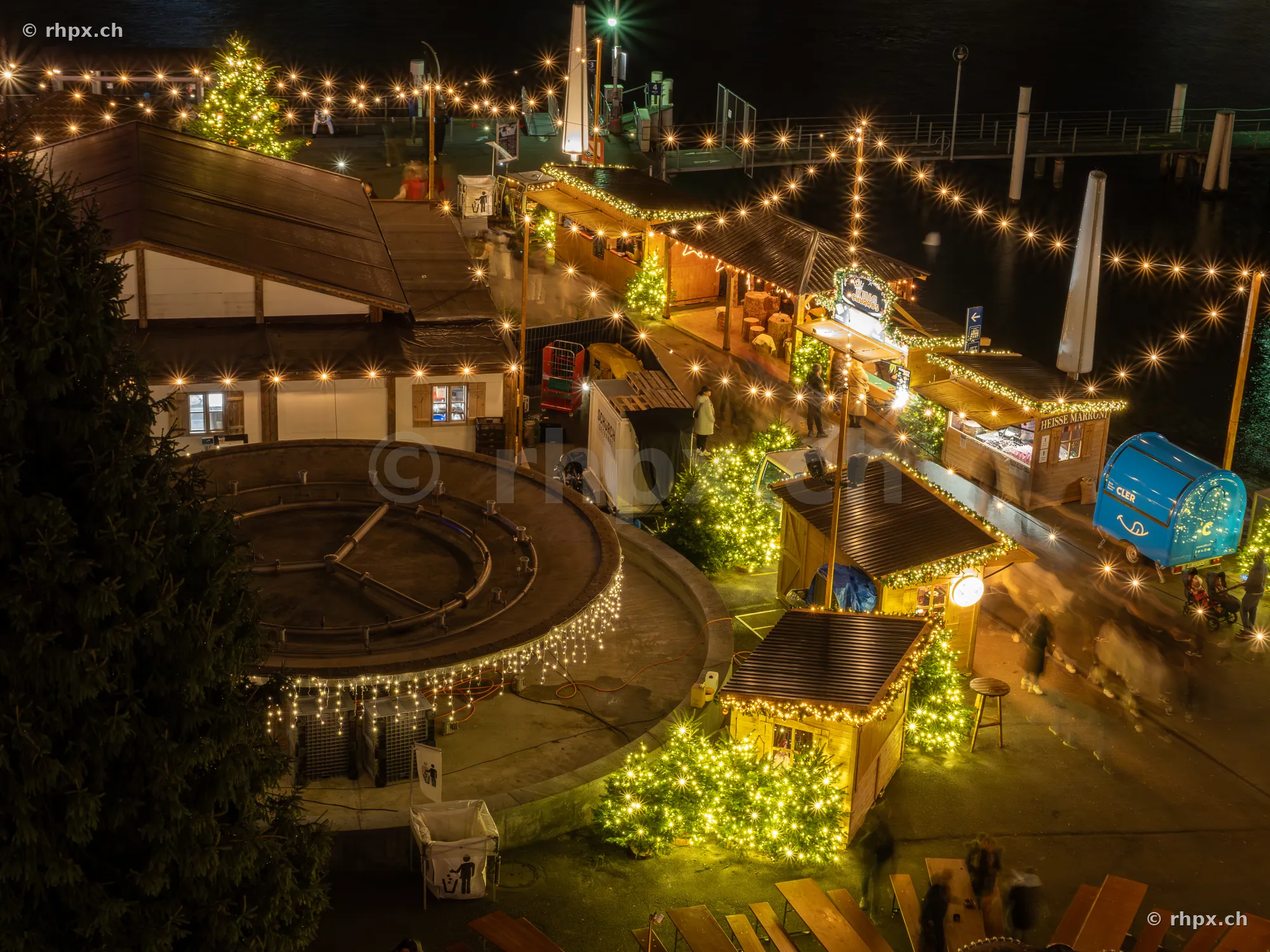 String lights and market stalls at the festively illuminated lakeside in Lucerne