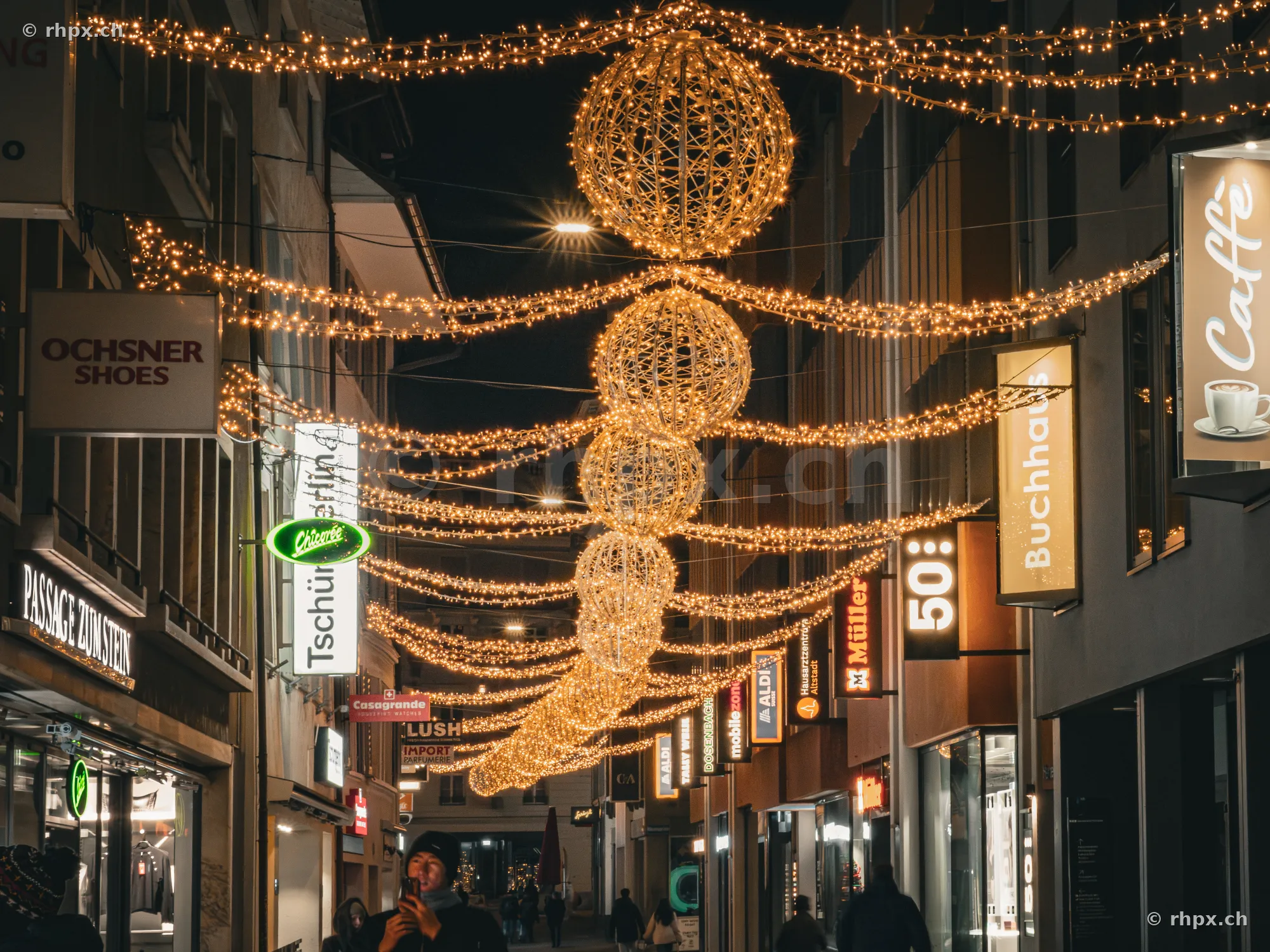 Christmas decorations with glowing orbs in a street of Lucerne's old town
