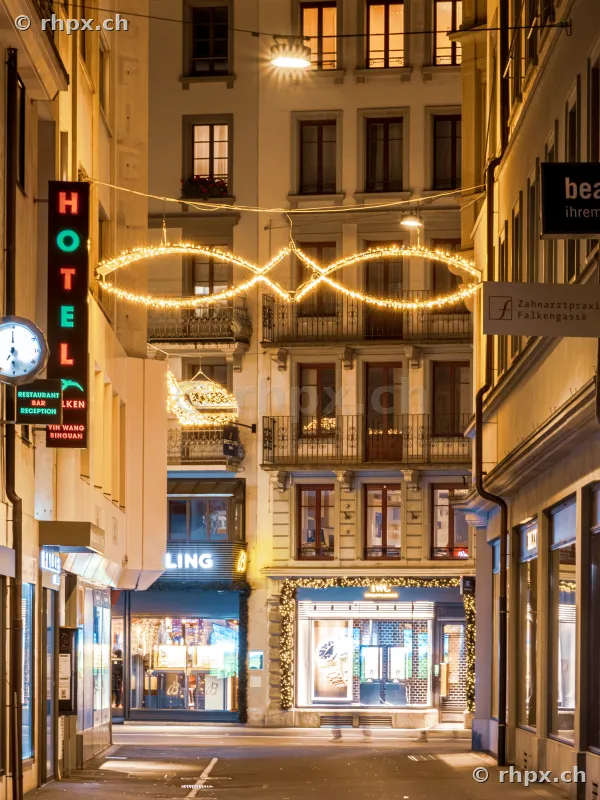 Nighttime alley in Lucerne with festive Christmas decorations and illuminated shop windows
