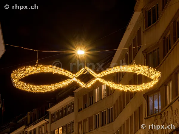 Illuminated Christmas street decoration shaped like an infinity loop in Lucerne