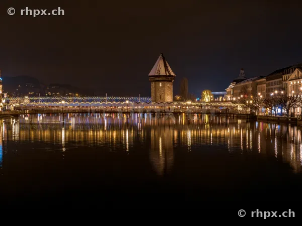 Night view of the illuminated Chapel Bridge in Lucerne at night