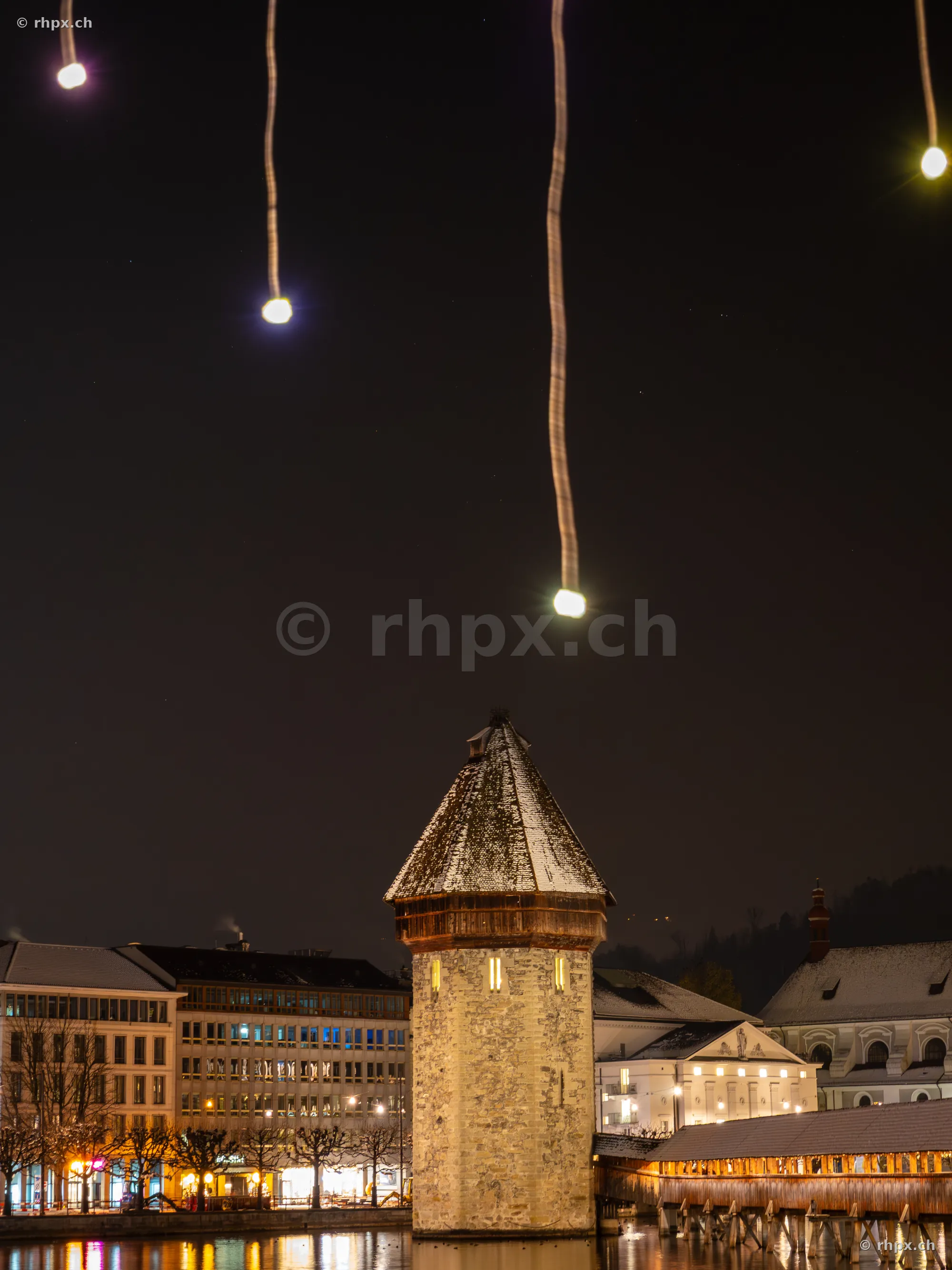 Illuminated Christmas decoration above the Water Tower in Lucerne at night