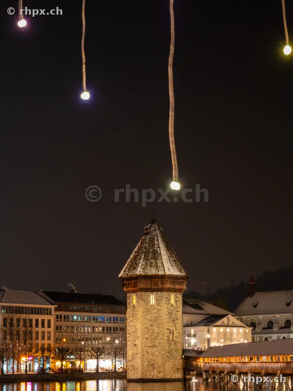 Illuminated Christmas decoration above the Water Tower in Lucerne at night