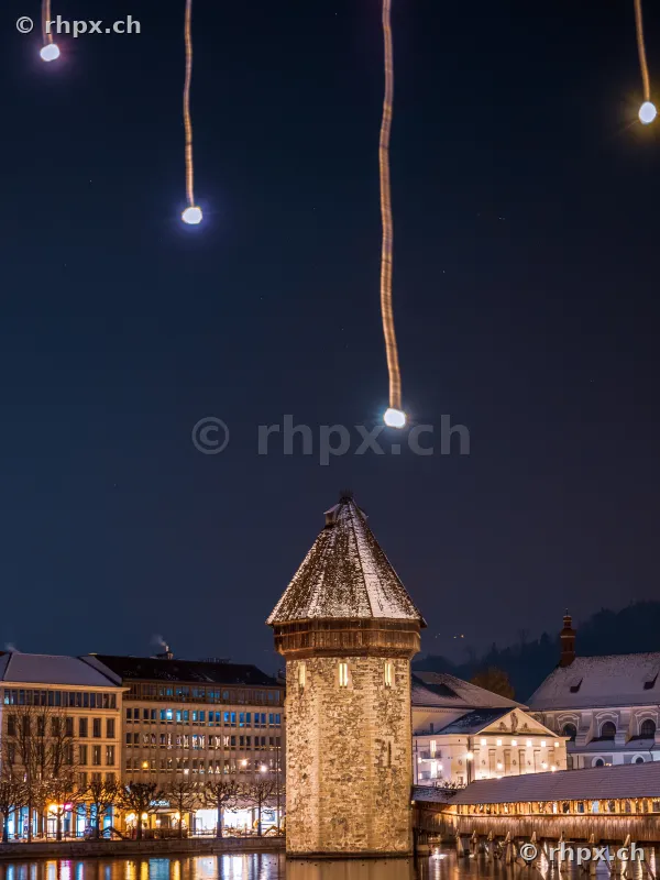 Water tower of the Chapel Bridge in Lucerne with nightly Christmas lighting