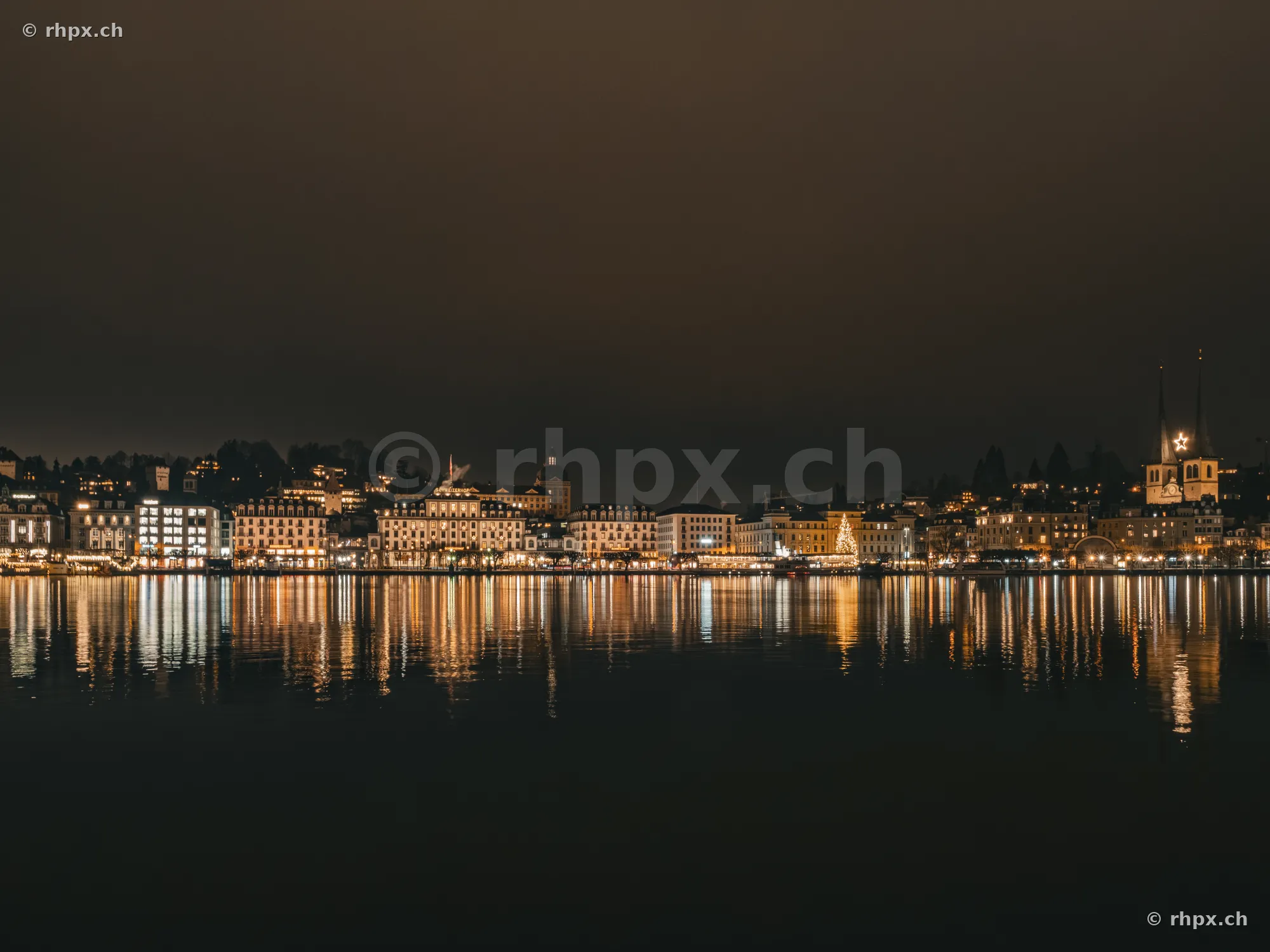 The night skyline of Lucerne with festive lights on Lake Lucerne