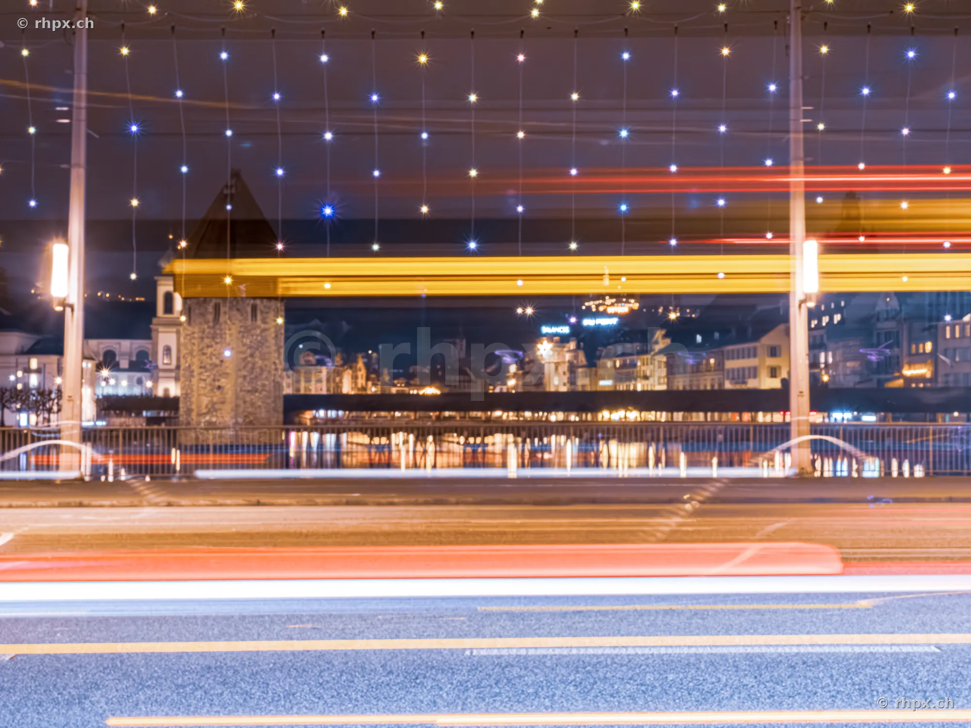 Langzeitbelichtung der weihnachtlichen Beleuchtung an der Seebrücke in Luzern mit Wasserturm im Hintergrund