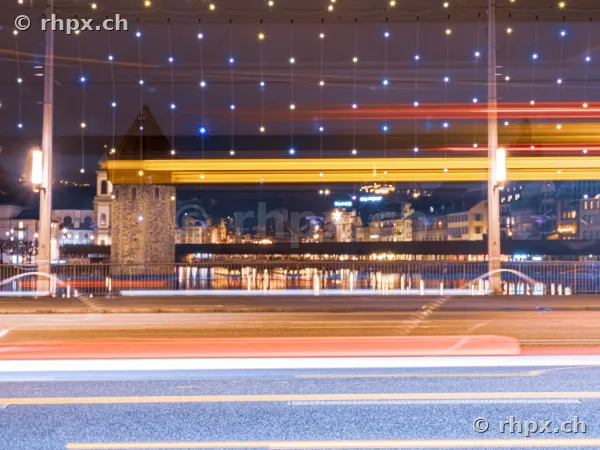 Long exposure of Christmas lighting at the Seebrücke in Lucerne with the water tower in the background