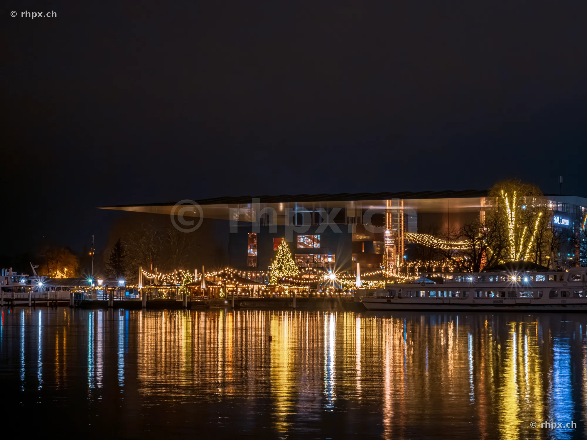 Christmas lights at KKL Lucerne on Lake Lucerne at night