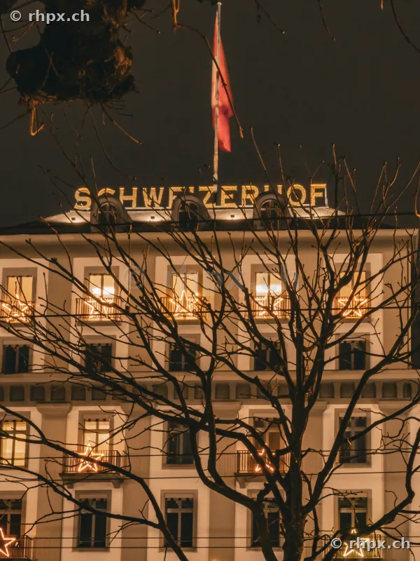 Facade of Hotel Schweizerhof in Lucerne with Christmas lights at night