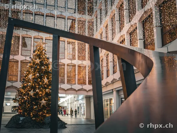 Christmas tree and string lights in a modern courtyard in Lucerne