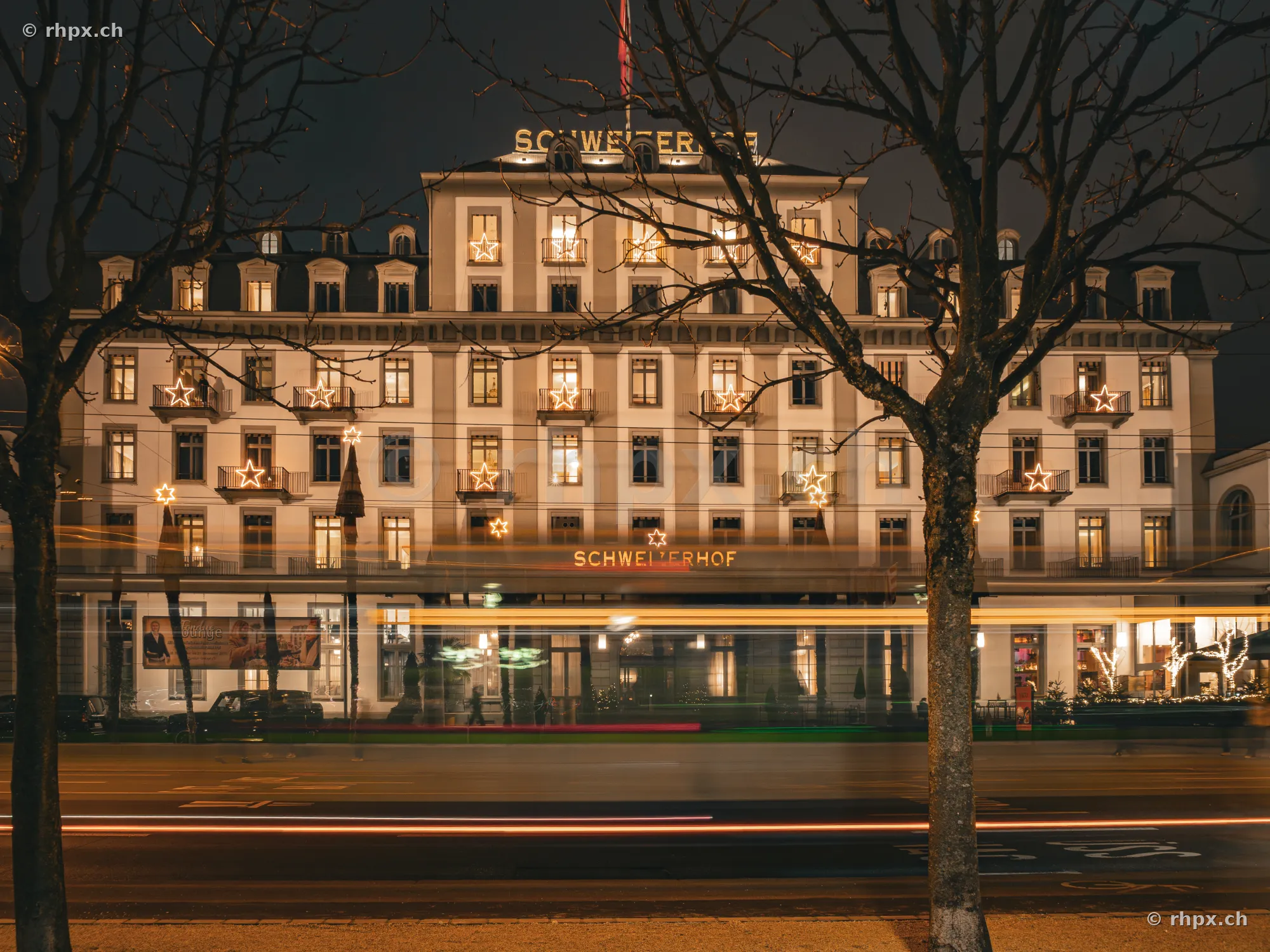 Hotel Schweizerhof in Lucerne at night with illuminated stars on the facade
