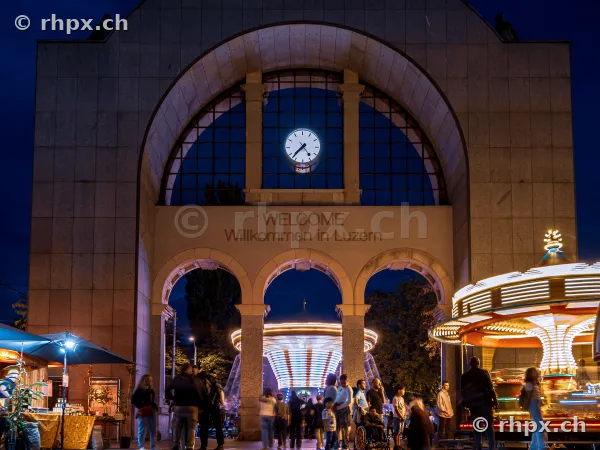Lucerne station gate at night with autumn fair carousel