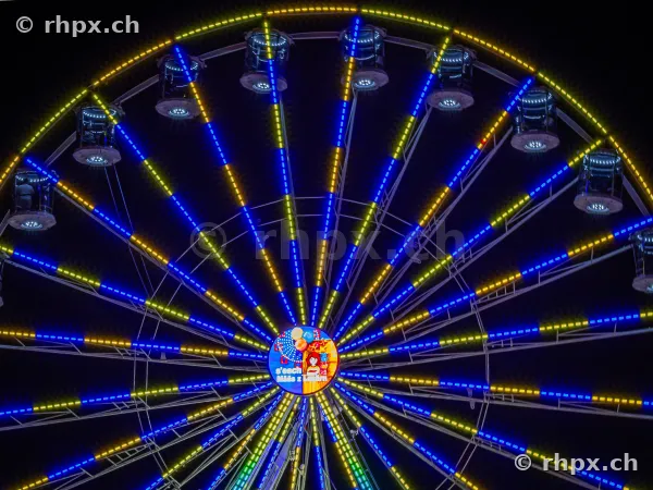 Illuminated Ferris wheel at the Lucerne autumn fair at night