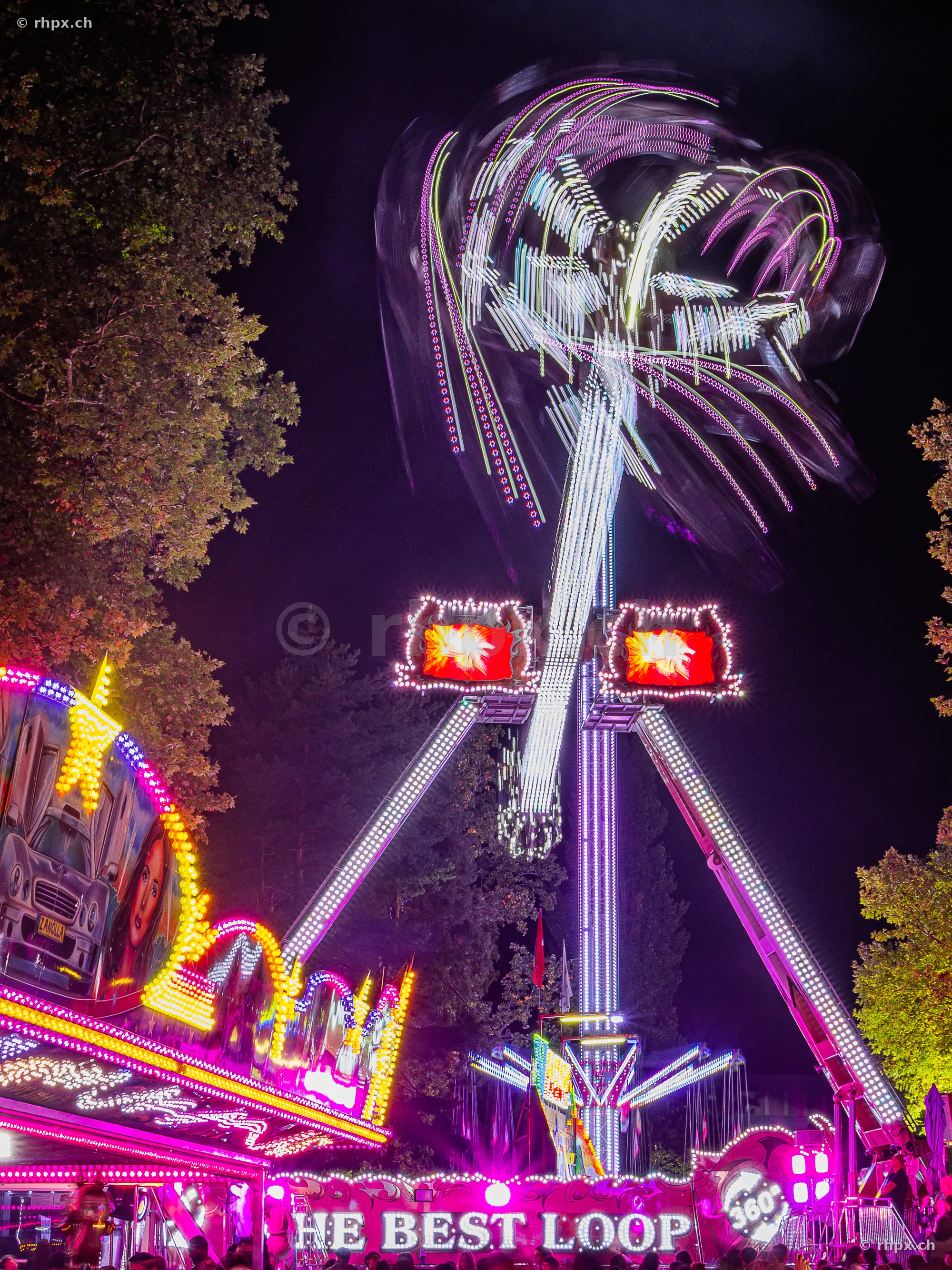 Long exposure of an illuminated fairground ride at the Lucerne autumn fair at night