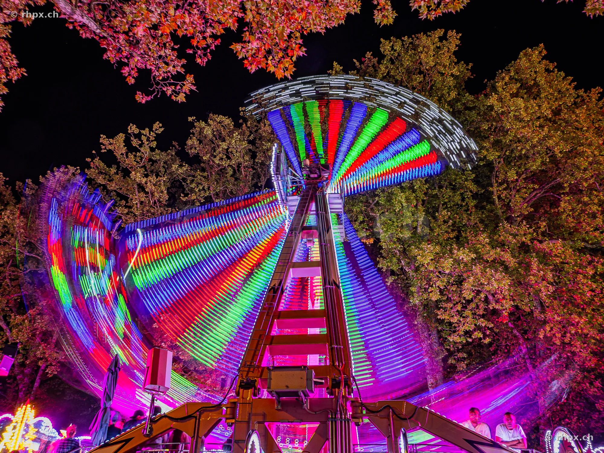 Illuminated fairground ride at the Lucerne autumn fair at night