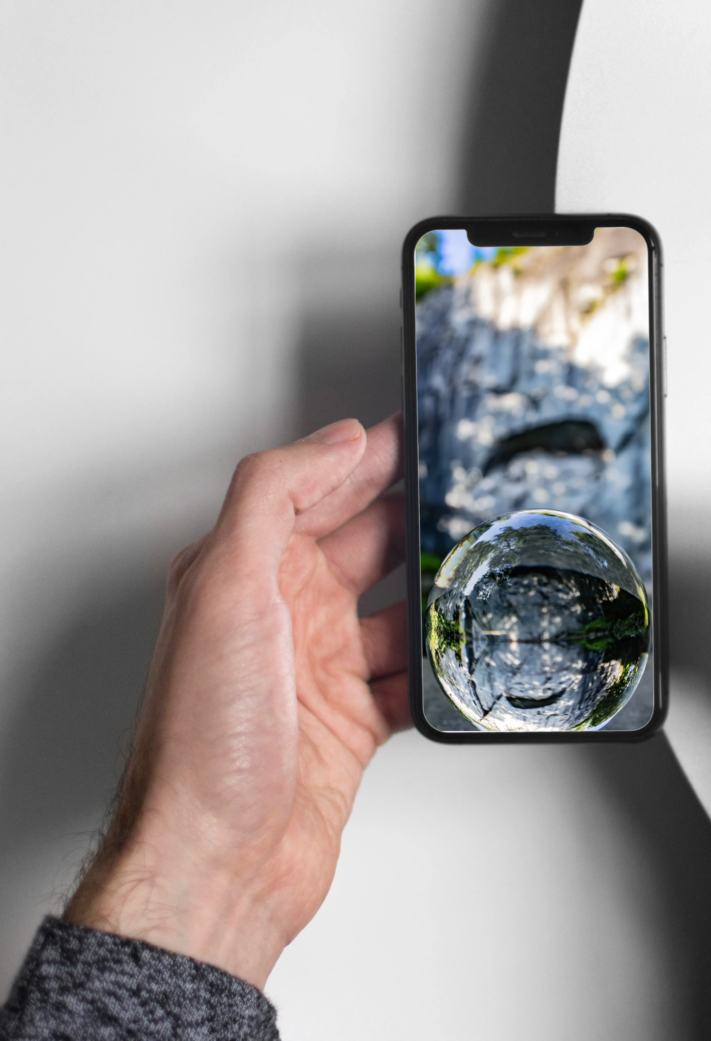 Reflection of the rock face in a glass sphere