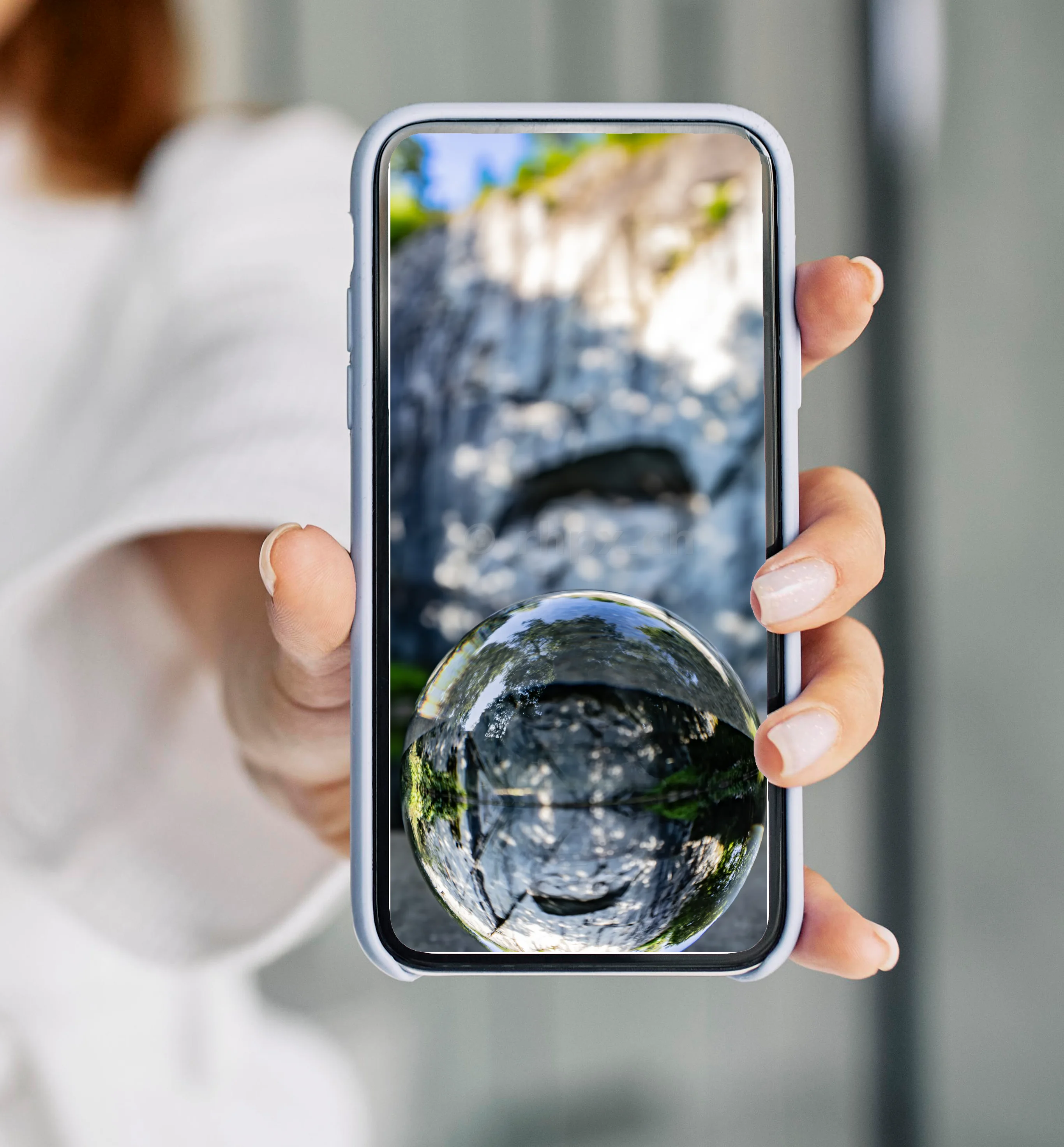 Reflection of the rock face in a glass sphere